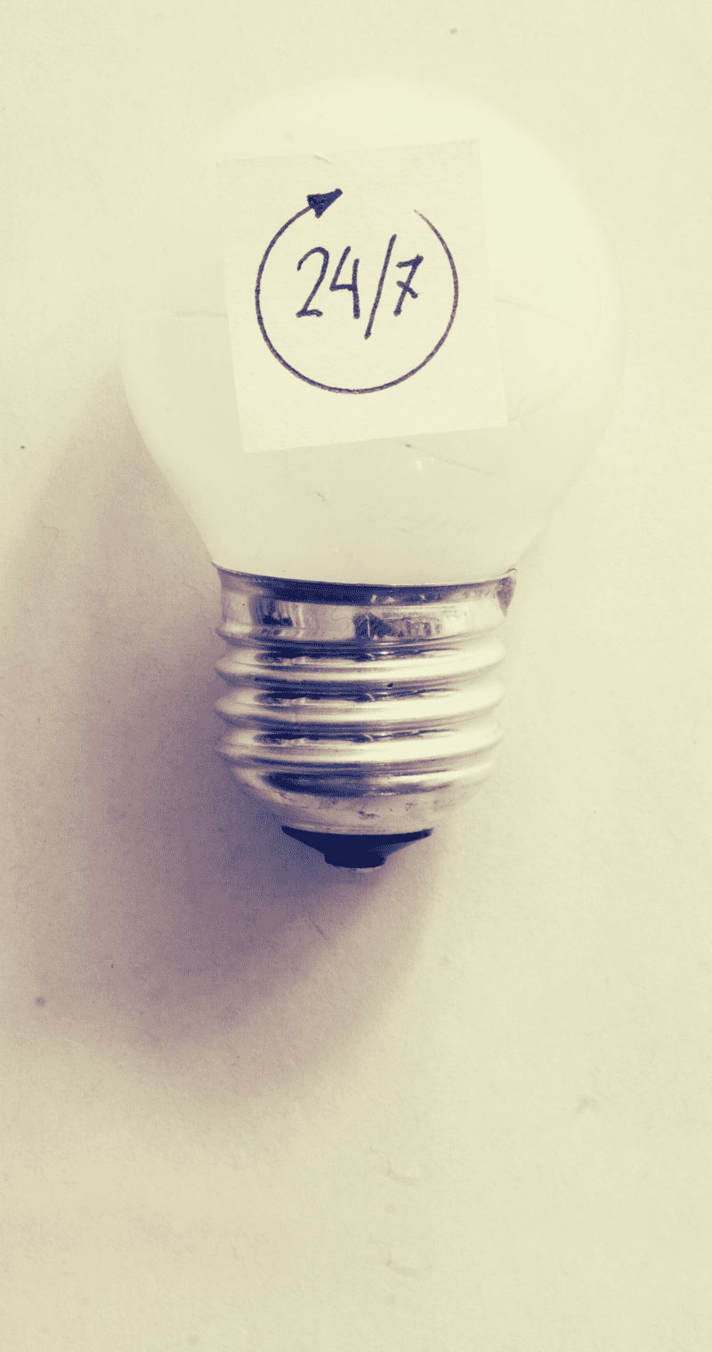 Light bulb with yellow background and its shadow